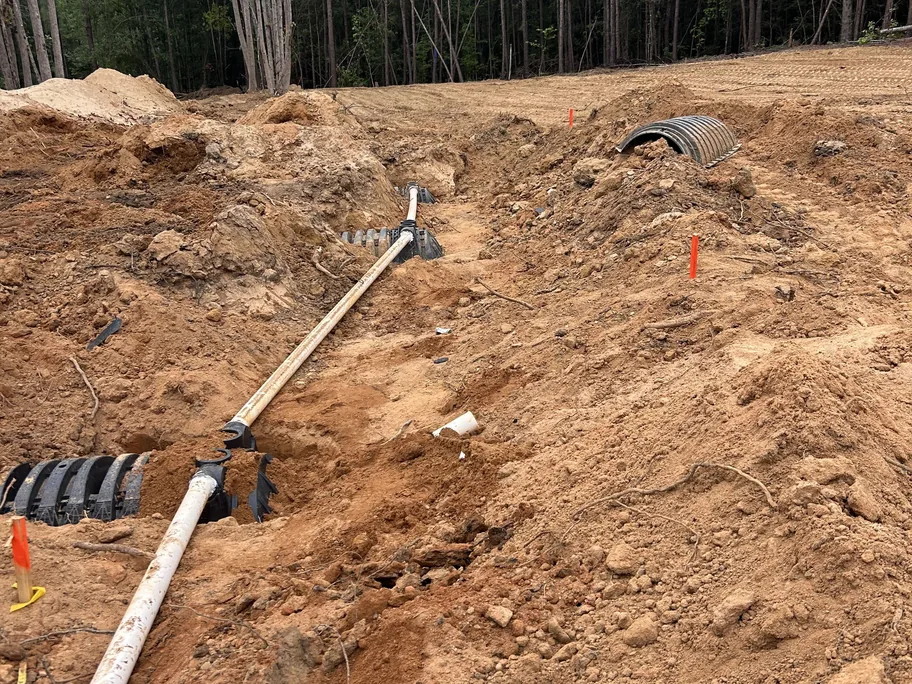 PVC line feeding several rows of drain field chambers, commercial septic systems