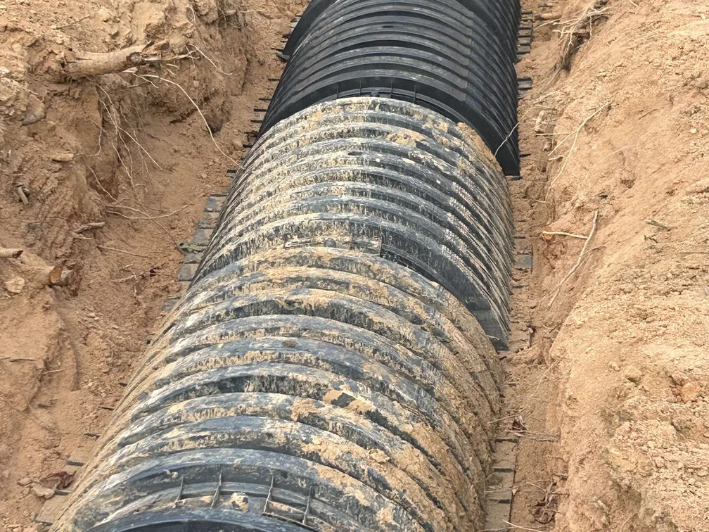 Drain field chambers laid end to end in an open trench, drain field repair