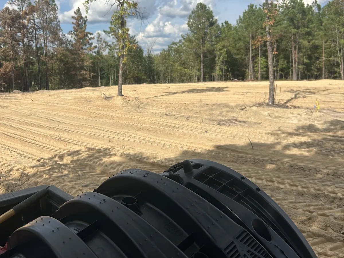 Drain field chambers on a truck at a cleared lot, mobile home septic systems