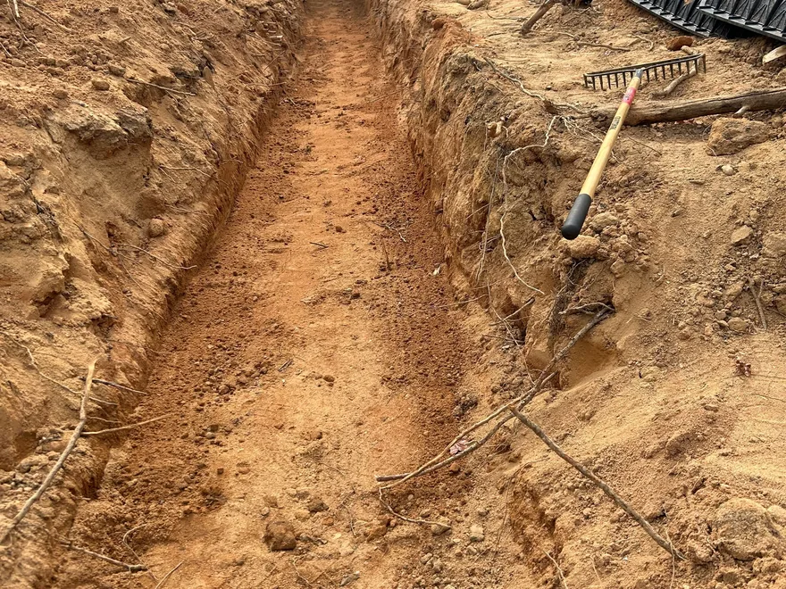 Open trench in red clay with chambers on the bank, mobile home septic systems